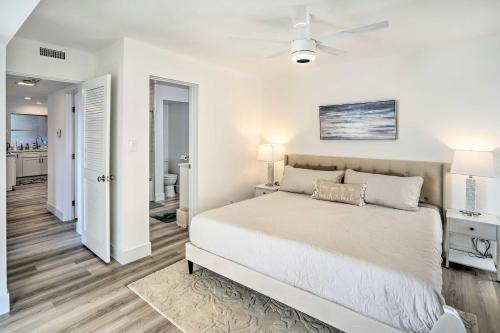 a white bedroom with a bed and a ceiling fan at San Clemente Condo with Gorgeous Views Near Beach! in San Clemente