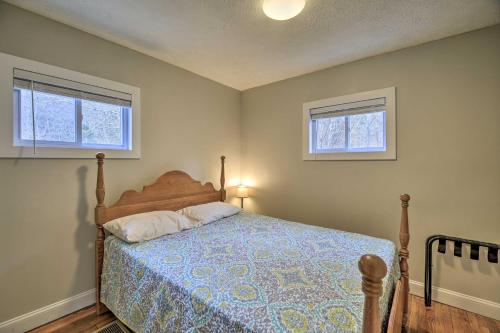 a bedroom with a bed and two windows at Mullens Cabin with Gas Grill and Mountain Views! in Mullens