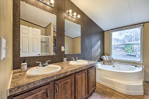 a bathroom with two sinks and a tub and a mirror at Ozark Mountain Cabin Rental on 300-Acre Ranch in Ozark