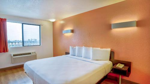 a hotel room with a large bed and a window at Motel 6-Los Angeles, CA - Los Angeles - LAX in Inglewood