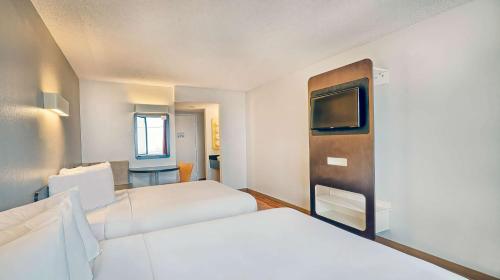 a hotel room with two beds and a tv at Motel 6-Los Angeles, CA - Los Angeles - LAX in Inglewood