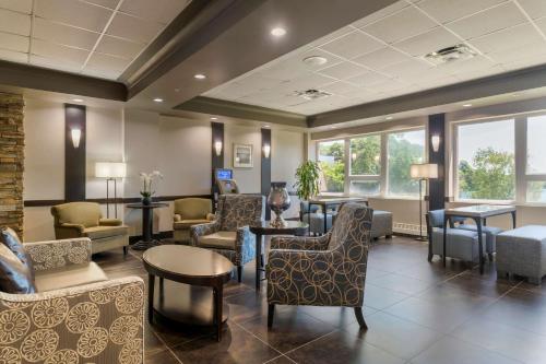 a waiting room with chairs and tables and windows at Best Western Plus Chocolate Lake Hotel - Halifax in Halifax