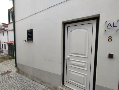 a door on the side of a white building at Segredos da Montanha by RetiroDoResende - Quarto Isolado in Seia