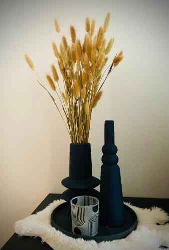 a table with two hats and a vase with flowers at L'antre du loup in Stavelot