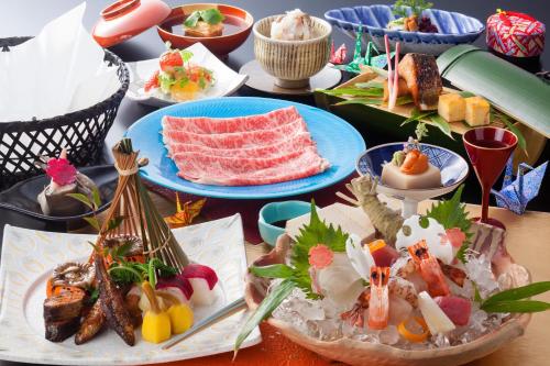 a table with many plates of food on it at Biwako Ryokusuitei in Otsu