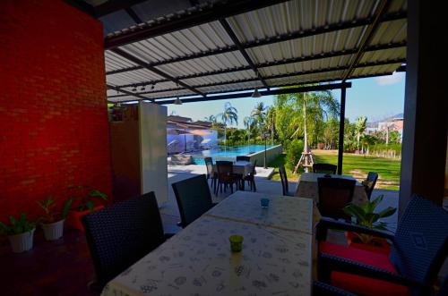 a dining room with a table and chairs and a pool at The Fusion Resort Hotel in Chalong