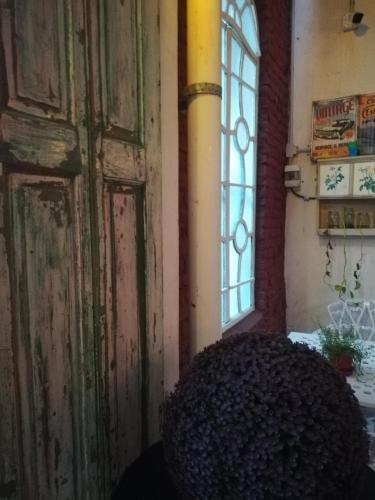 an old door in a room with a window at HOTEL Boutique Casablanca Adrogué in Adrogué