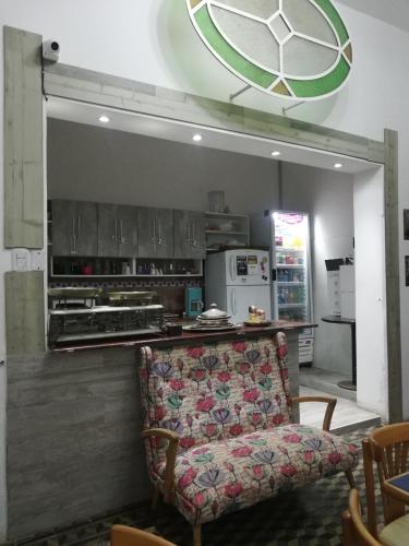 a living room with a couch and a kitchen at HOTEL Boutique Casablanca Adrogué in Adrogué