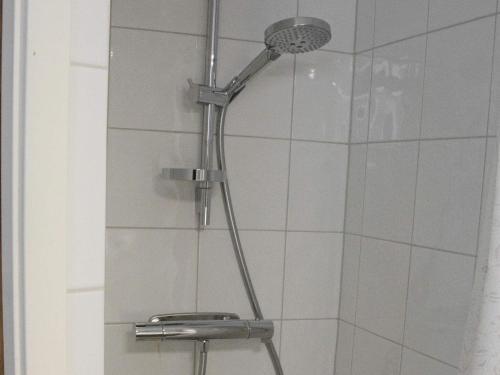 a shower with a shower head in a bathroom at 3 person holiday home in HAMMARÖ-By Traum in Hammarö