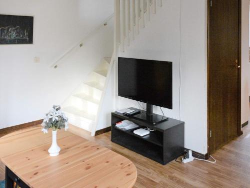 a living room with a tv and a table at 3 person holiday home in HAMMARÖ-By Traum in Hammarö
