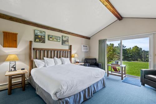 a bedroom with a bed and a large window at North Shire Lodge in Manchester