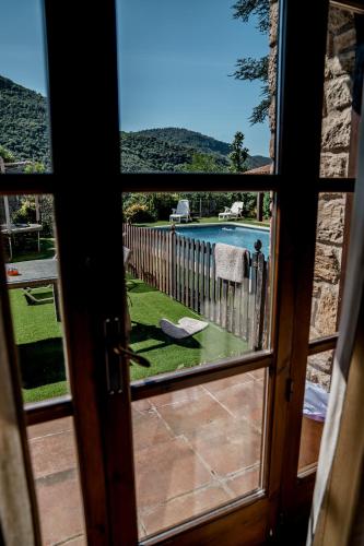 a view from a door looking out at a pool at Casa les Pomeretes in El Figaró