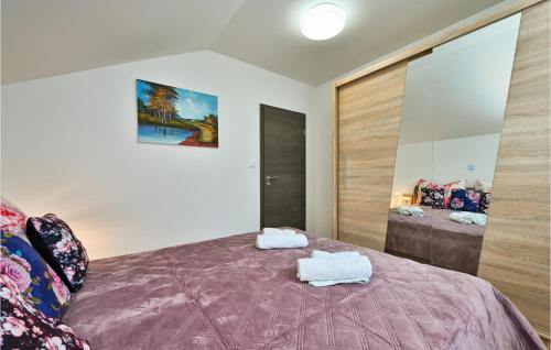 a bedroom with a bed with two towels on it at Awesome Home In Dugo Selo With Outdoor Swimming Pool in Dugo Selo