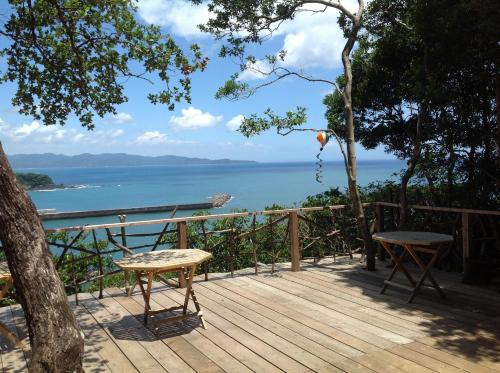 a wooden deck with a view of the water at Yamamizuki in Shimanto