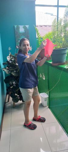 a young girl standing in a room with a potted plant at Hotel Trianon in San José