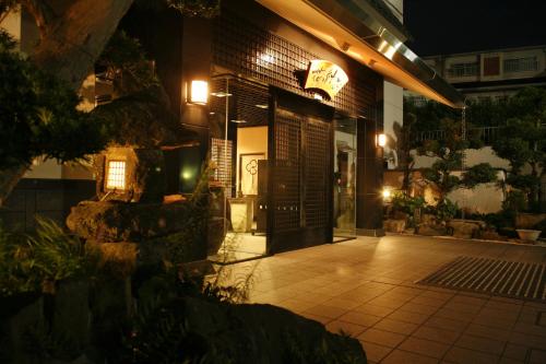 a front door of a building at night at Arima Hot Spring Ryokan Hanamusubi in Kobe