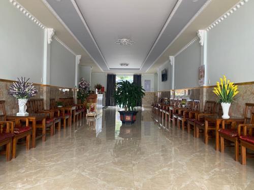 a large room with wooden tables and chairs at Phuong Dung Hotel in Buon Ma Thuot
