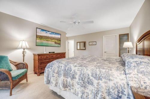 a bedroom with a bed and a chair and a dresser at WAILEA ELUA, #2501 condo in Wailea
