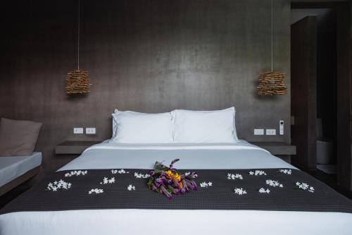 a bedroom with a bed with flowers on it at Panorama Villas El Nido in El Nido