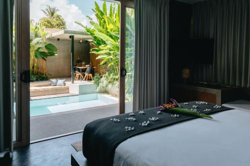 a bedroom with a bed and a view of a garden at Panorama Villas El Nido in El Nido