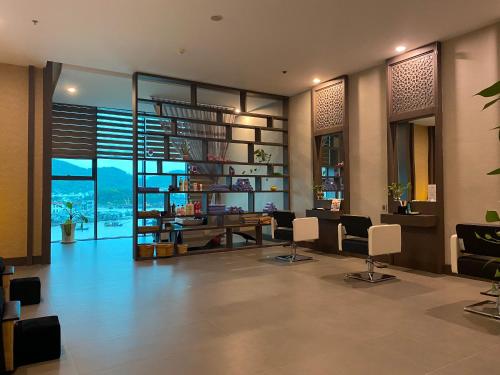 a lobby with a spiral staircase and a table and chairs at Muong Thanh Luxury Khanh Hoa in Nha Trang