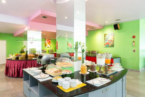 a restaurant with a buffet with food on it at Bella Villa Metro in Pattaya North