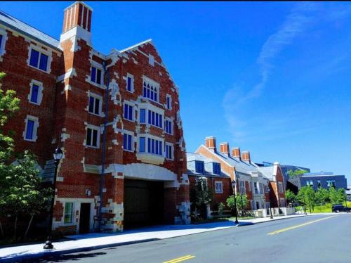 a red brick building with a tower on a street at Golden Gem in Heart of East Rock Quiet 3BR Near DT and Yale in New Haven
