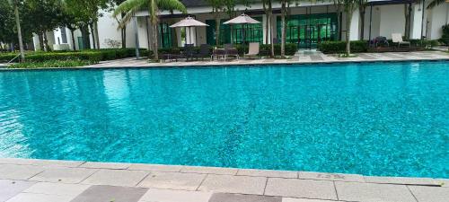 a large blue swimming pool in front of a building at Peace home B13 in Cyberjaya