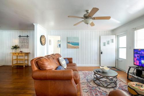 a living room with a couch and a ceiling fan at 5BR House King Beds Steps To Beach Ideal for Families With Dogs in Myrtle Beach