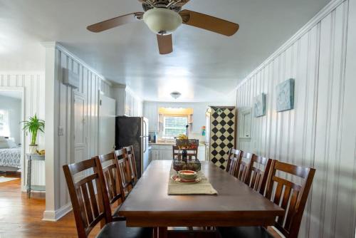 a dining room table with chairs and a ceiling fan at 5BR House King Beds Steps To Beach Ideal for Families With Dogs in Myrtle Beach