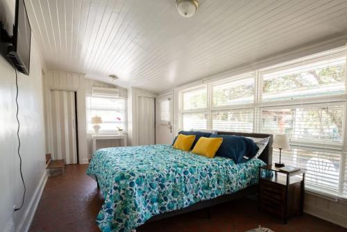 a bedroom with a bed with blue and yellow pillows at 5BR House King Beds Steps To Beach Ideal for Families With Dogs in Myrtle Beach
