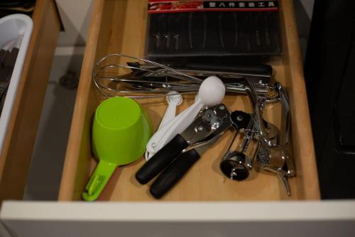 a drawer filled with kitchen utensils and a green cup at Modern 4BR Ground Level King Beds Steps 2 Beach C in Myrtle Beach