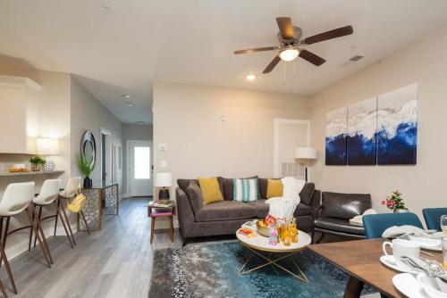 a living room with a couch and a table at Lovely 4BR King Beds Steps To Beach And Pier G in Myrtle Beach