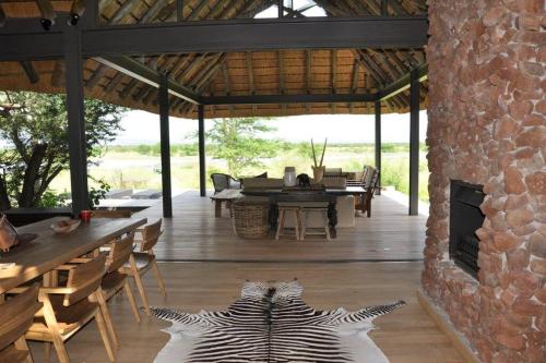 a zebra rug on the floor of a patio at Imvubu Lodge, Royal Jozini PGR, eSwatini in Lavumisa