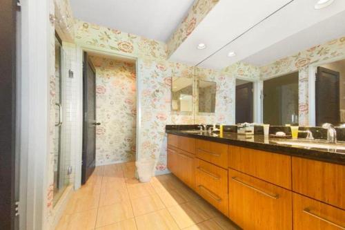 a bathroom with a sink and a large mirror at WAILEA GRAND CHAMPION, #148 condo in Wailea
