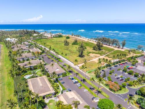 an aerial view of a parking lot next to the ocean at Kauai Plantation Hale Suites by Coldwell Banker Island Vacations in Kapaa