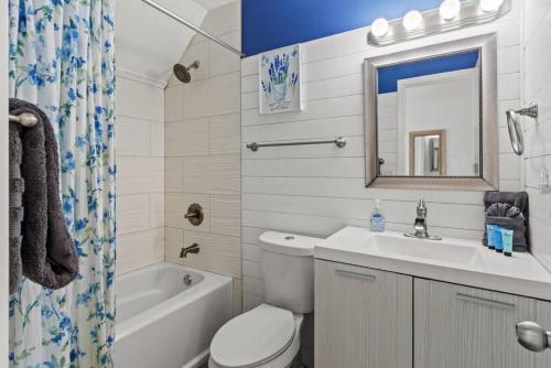 a bathroom with a sink toilet and a mirror at Seaside Serenity at Shiplap Shack, Updated Coastal Beach Home w Beach Gear and Idyllic Outdoor Living, Just Steps from the Shore in Panama City Beach