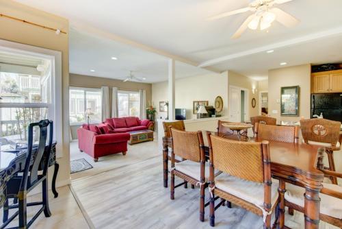 a dining room and living room with a table and chairs at Kauai Regency at Poipu Kai by Coldwell Banker Island Rentals in Koloa