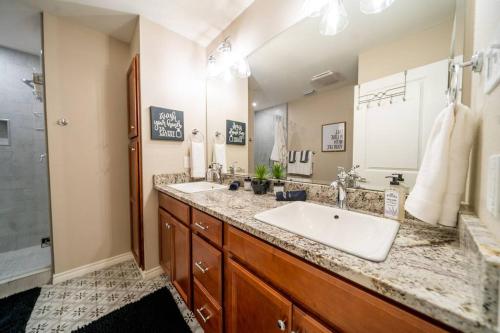 a bathroom with a sink and a large mirror at Gorgeous rustic home near River Walk and Sea World in San Antonio