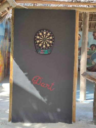 a dart board on a wall with a sign on it at Princess of Zanzibar in Michamvi
