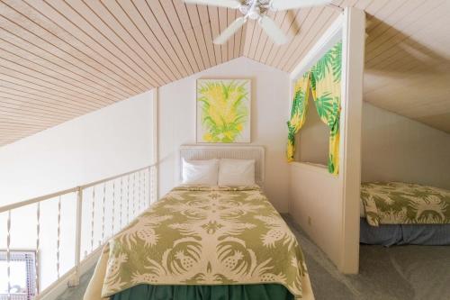 a bedroom with a bed and a ceiling fan at Turtle Bay Sea BreezeNUC 90-TVU-0498 in Kahuku