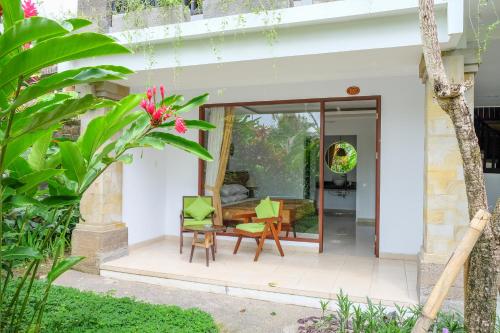 a patio with a table and chairs in a house at The Gaya in Ubud