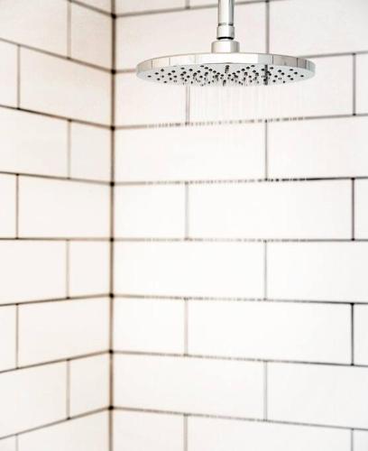 a light fixture hanging from a white tiled wall at Seascape on Bruny - Family Home in Alonnah in Alonnah