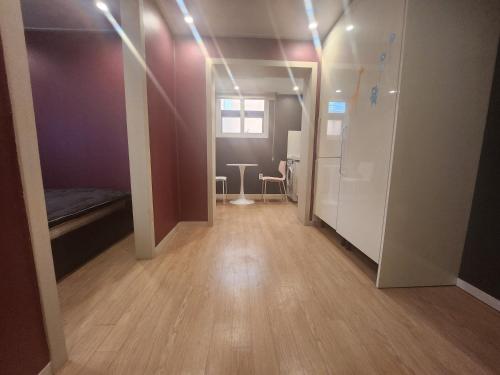 a room with a hallway with a bed and a table at Olive hostel R(Residence) in Seoul