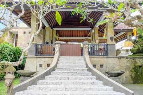 a set of stairs leading to a house with a gate at The Gaya in Ubud