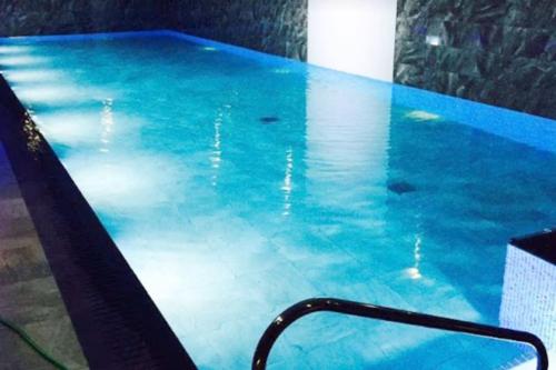 a swimming pool with blue water in a room at Meadowside, Troutbeck Bridge with offsite health club in Windermere