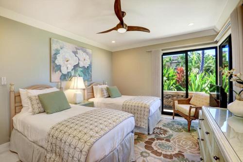 a bedroom with two beds and a ceiling fan at WAILEA ELUA, #1403 condo in Wailea