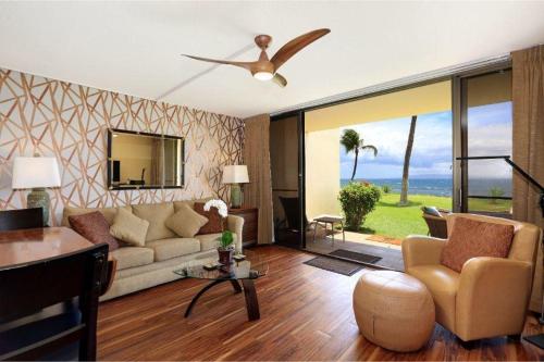 a living room with a couch and a ceiling fan at SUGAR BEACH RESORT, #129 condo in Kihei