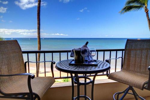 a table and chairs on a balcony with the ocean at SUGAR BEACH RESORT, #329 condo in Kihei
