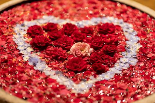 a heart made out of red and white flowers at KNN Luxury Hill in Sen Monorom